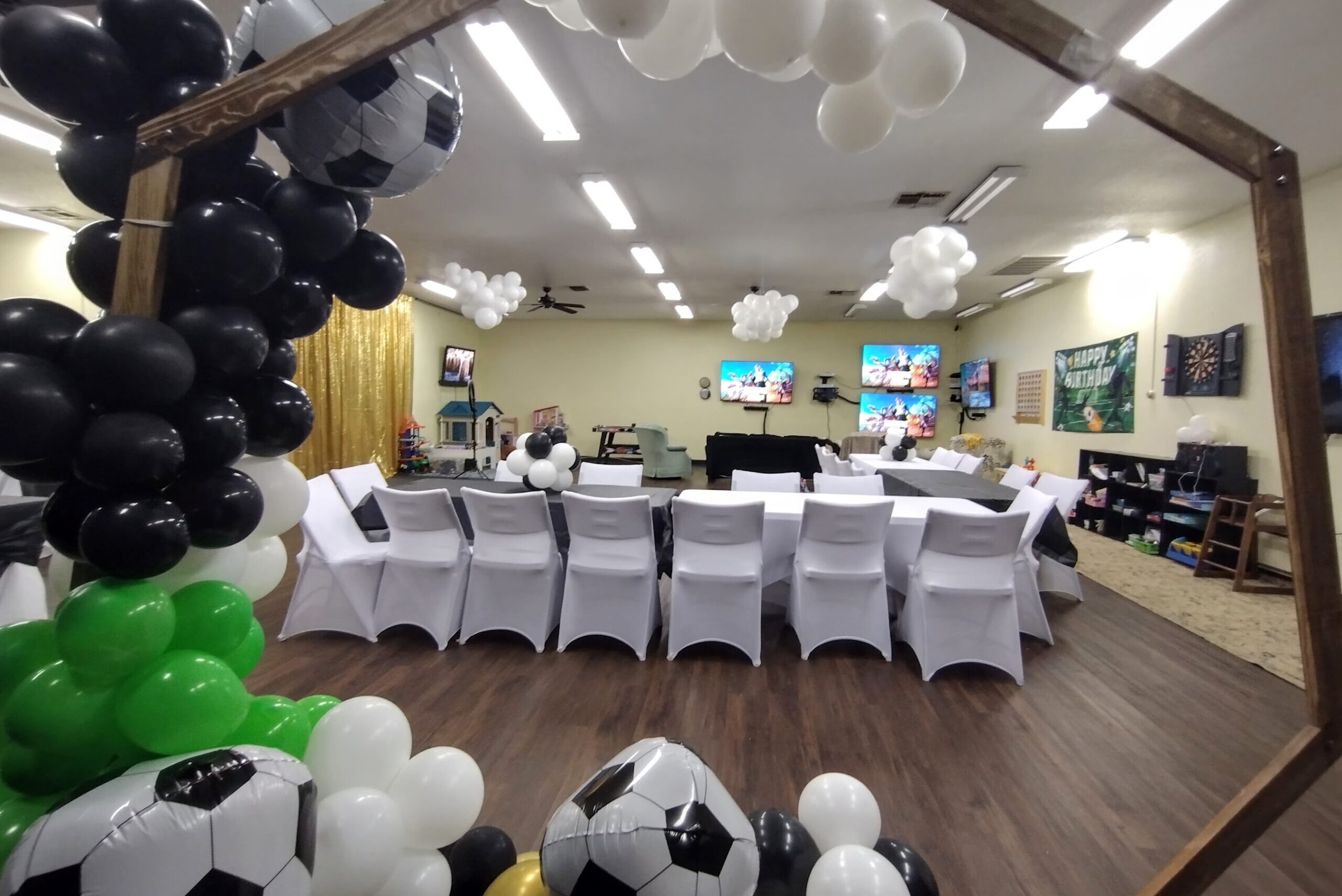 looking through the soccer theme balloon arch onto the guest floor and tables and chairs